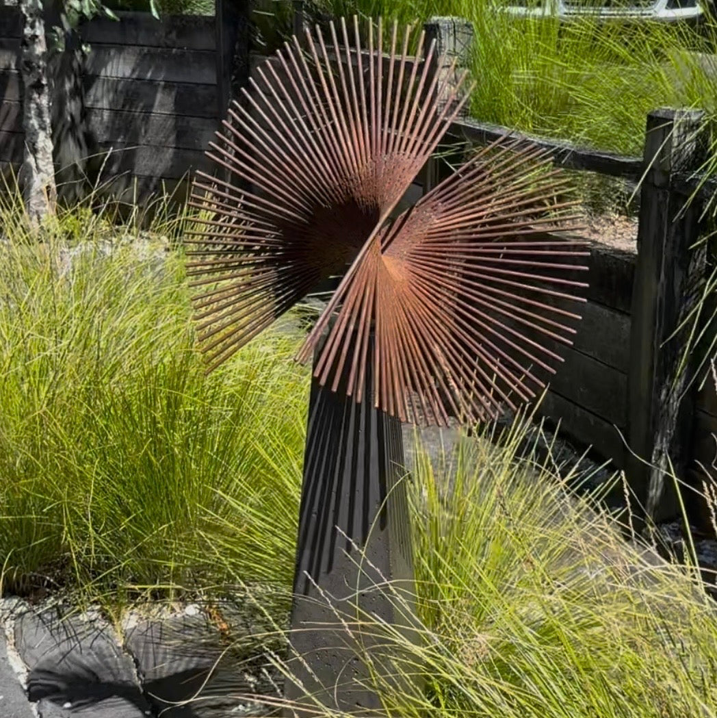 Decorative metal sculpture in a garden setting