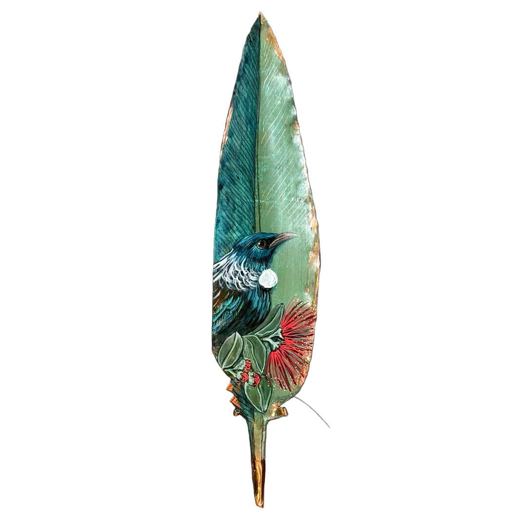 Decorative copper feather with a painted design of a Tui bird and flowers on a white background