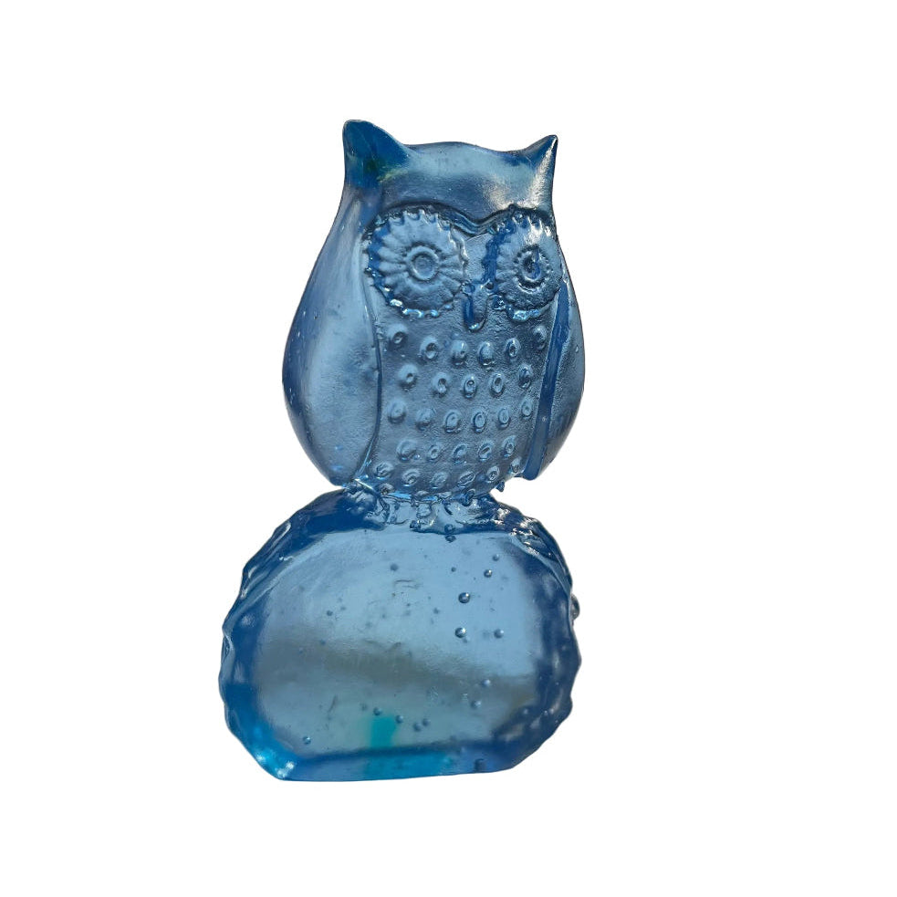 Blue glass owl sculpture on a white surface