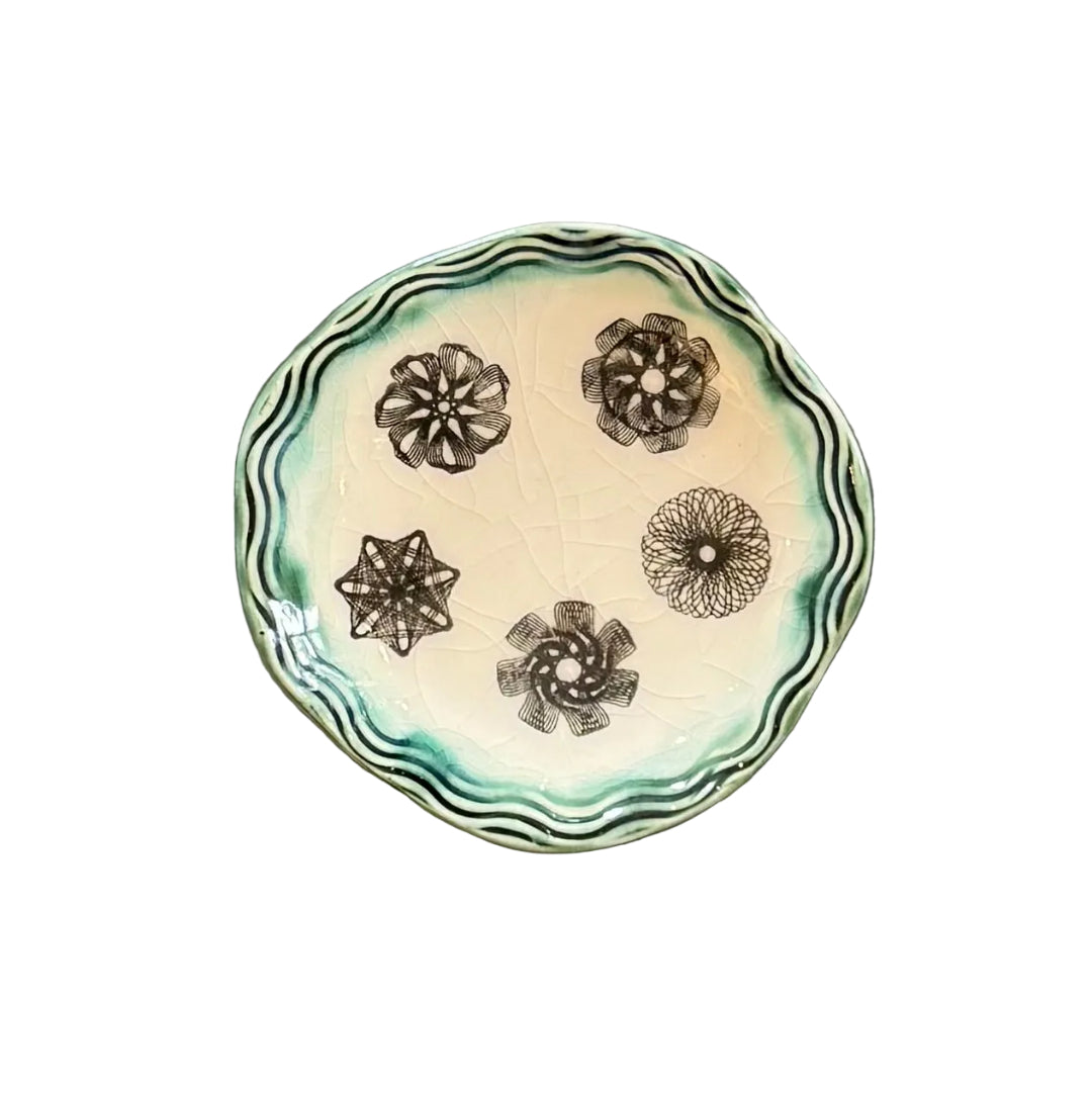 Ceramic plate with decorative geometric patterns on a white background