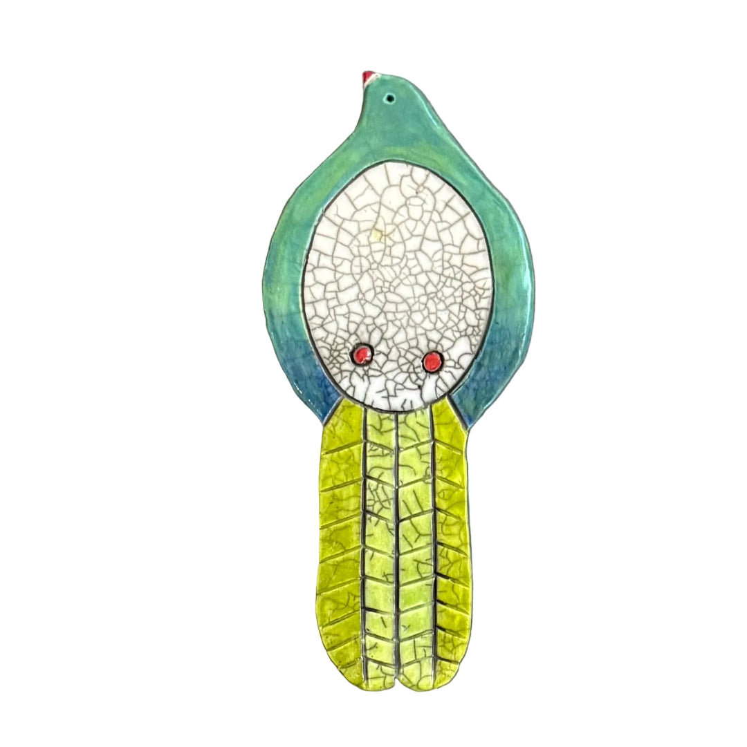 Colourful ceramic Kereru shaped wall tile on a white background
