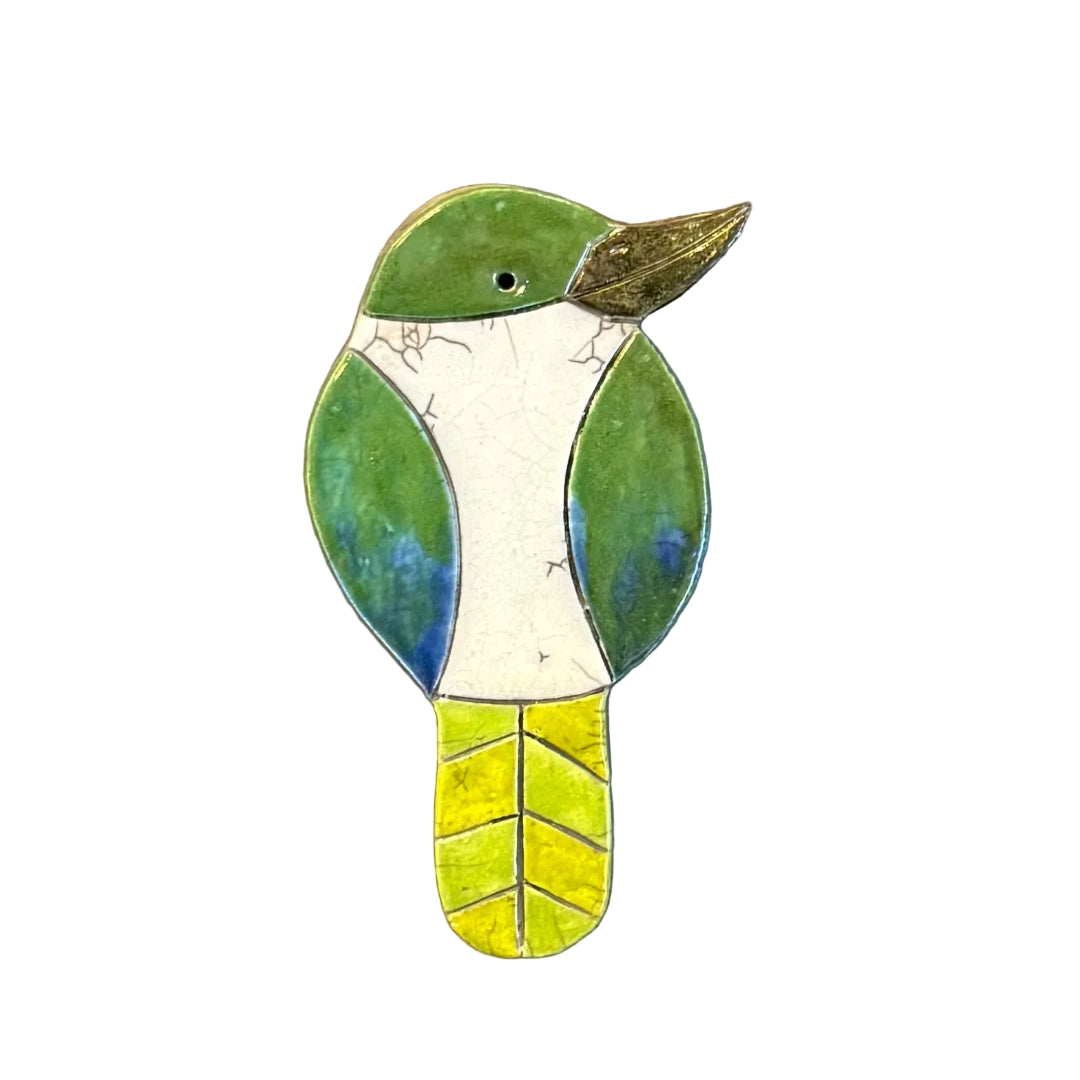 Colourful ceramic Kingfisher shaped wall tile on a white background