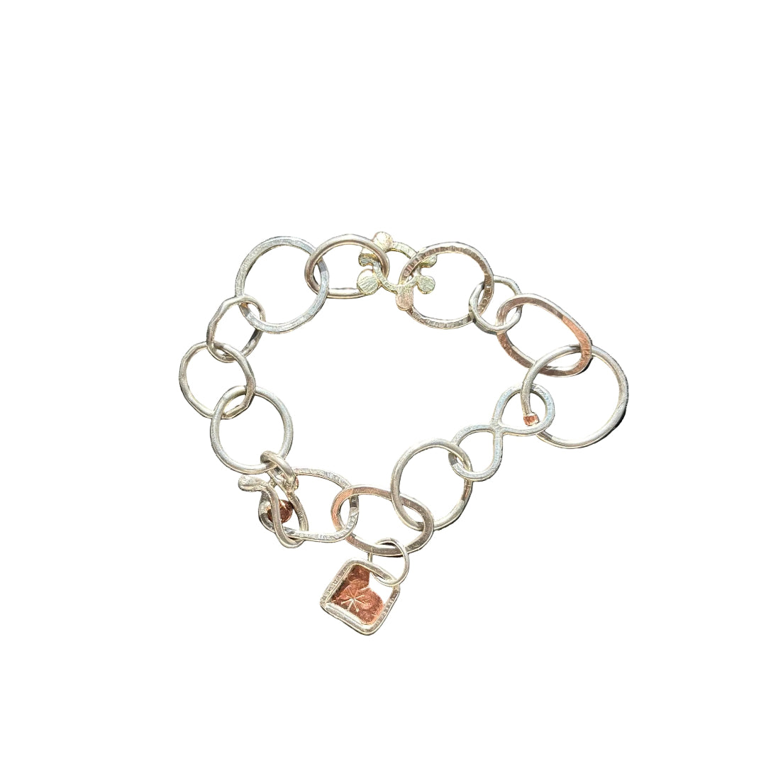 Silver chain bracelet with charms on a white background
