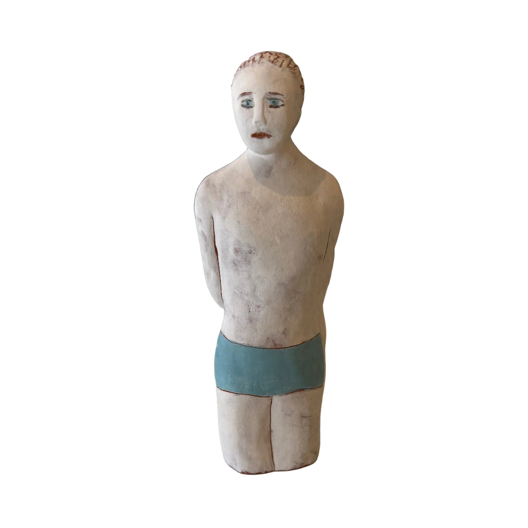 Ceramic male Swimmer in blue trunks on a white background.