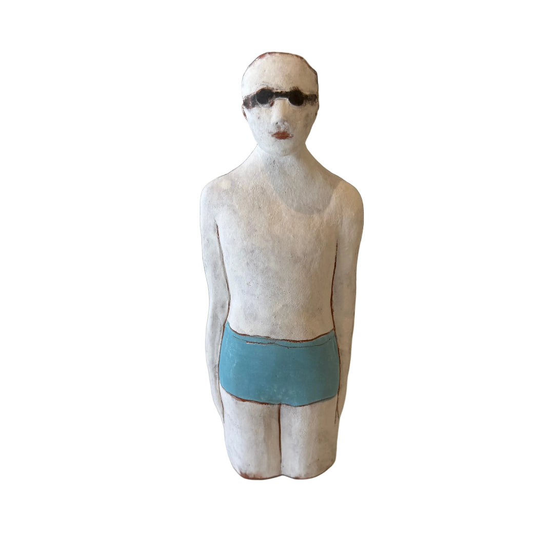 Ceramic sculpture of a male Swimmer in blue swimsuit with goggles  on a white background.