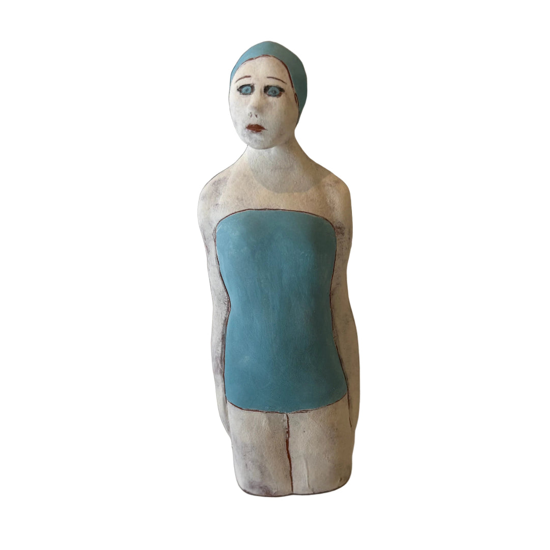 Ceramic sculpture of a Swimmer in blue swimsuit & cap on a white background