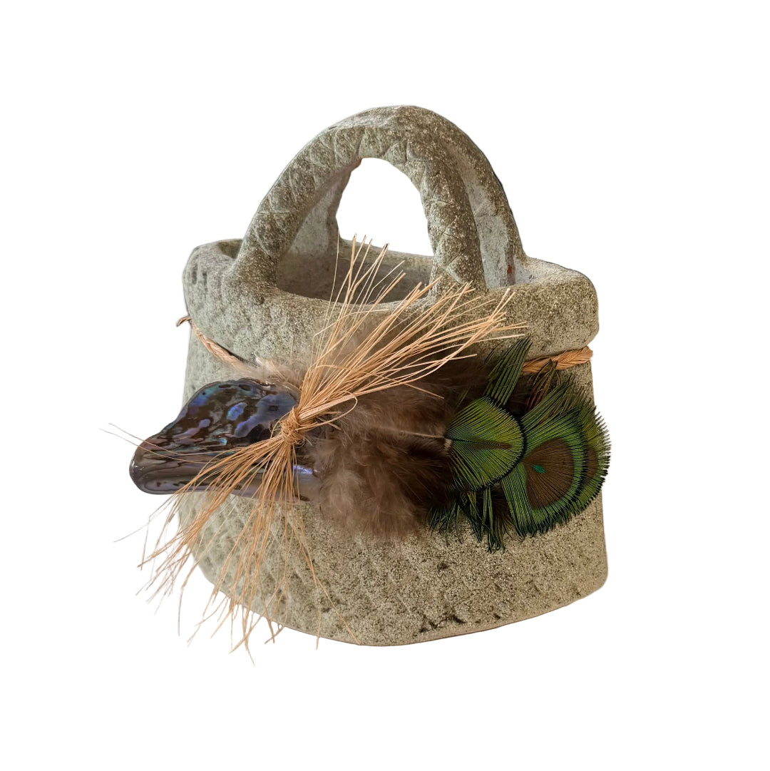 Decorative terracotta basket or kete with peacock feathers and paua shell decorationon 