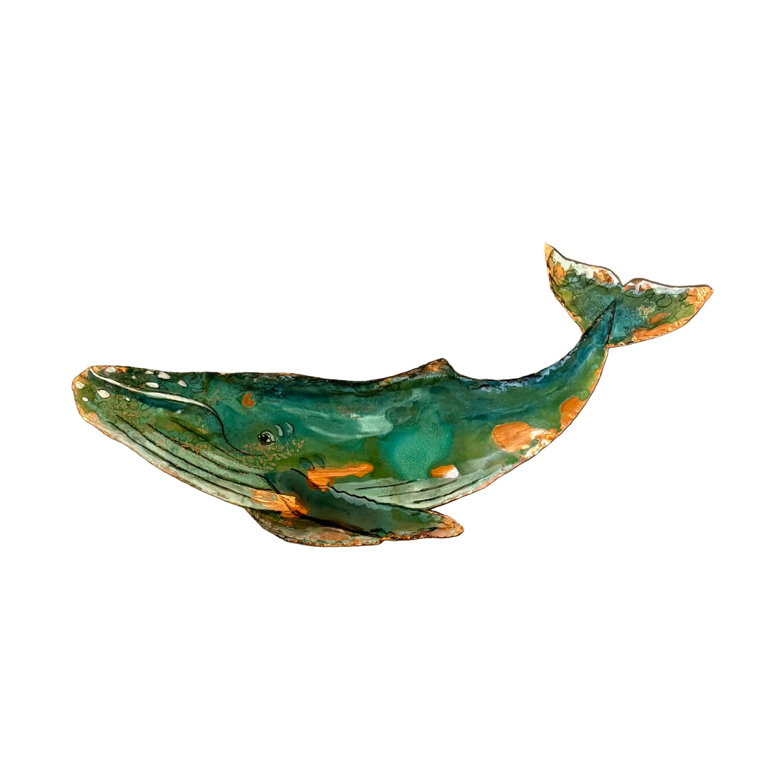 Decorative copper whale wall art on a plain background