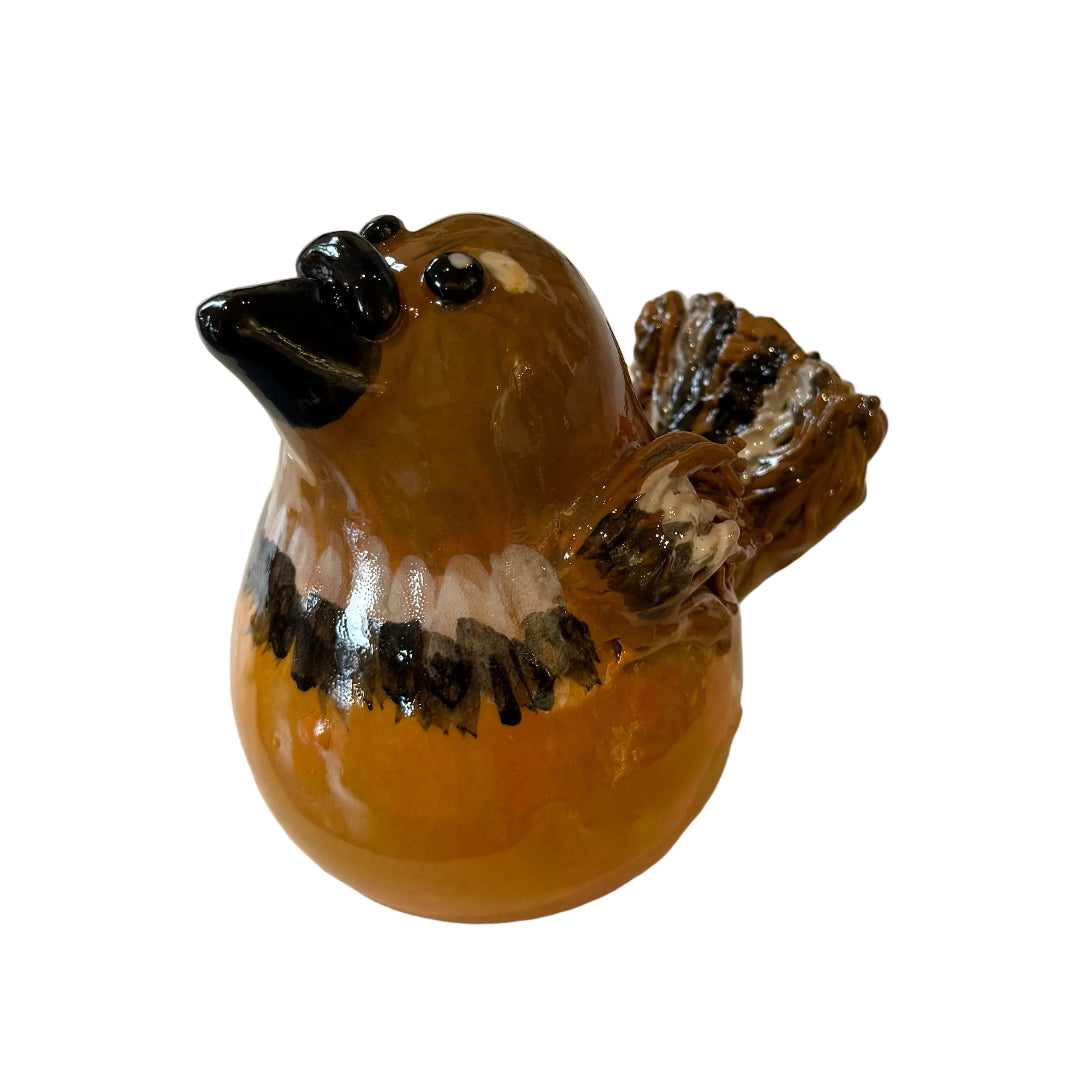 Ceramic Fantail sculpture with a black beak on a white background