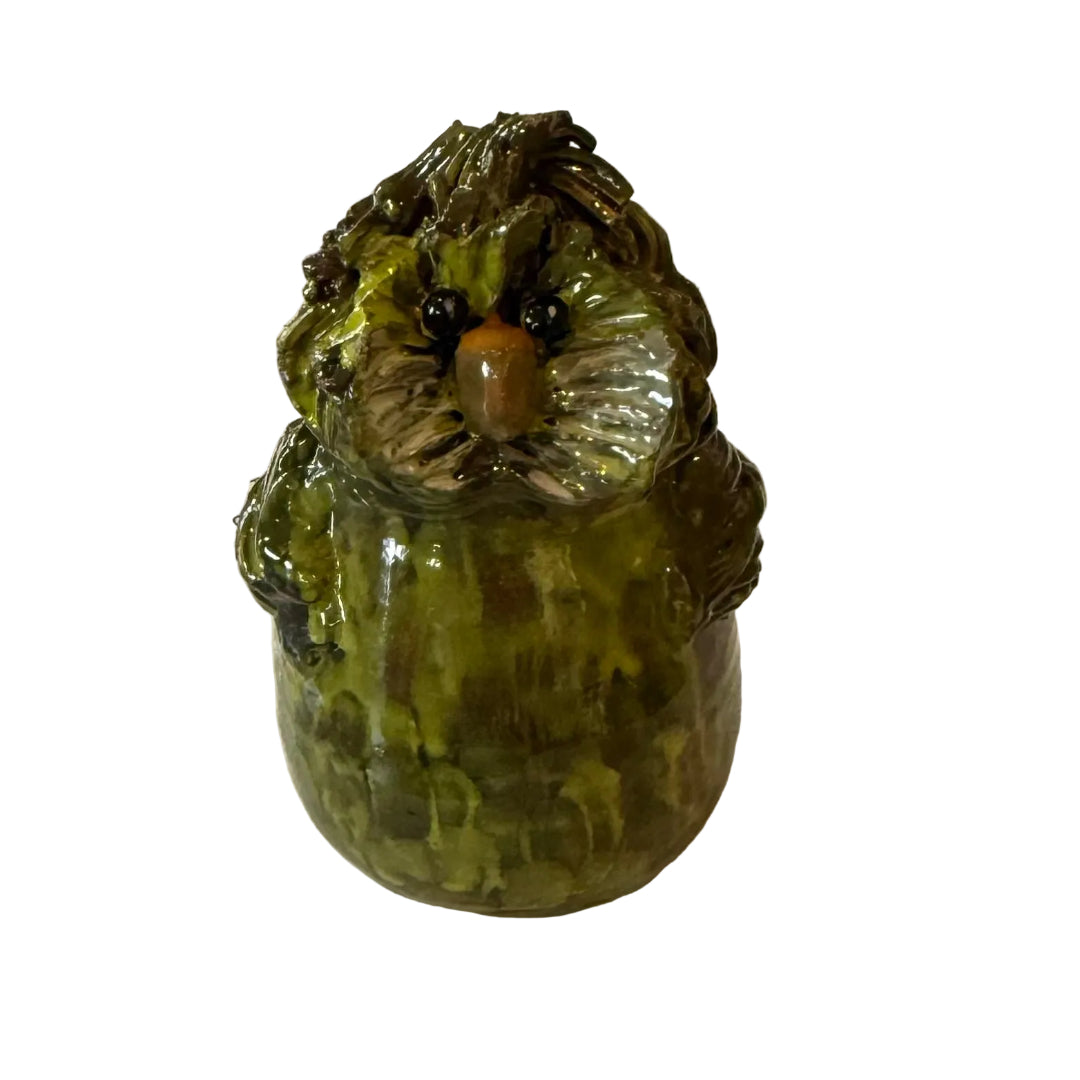 Ceramic Kakapo bird sculpture with an orange beak on a white background