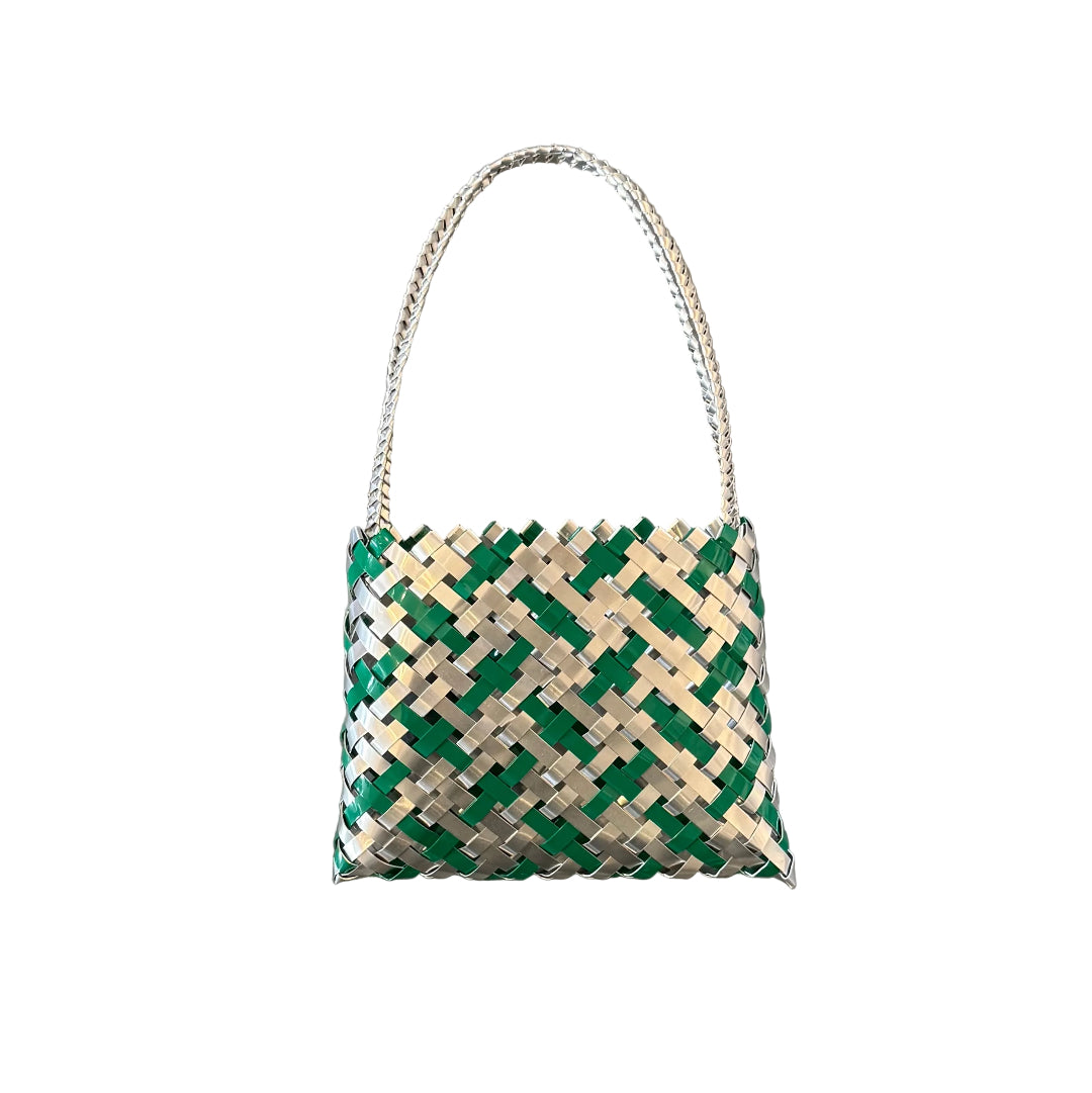 Woven green and silver aluminium wall kete or bag on a white background