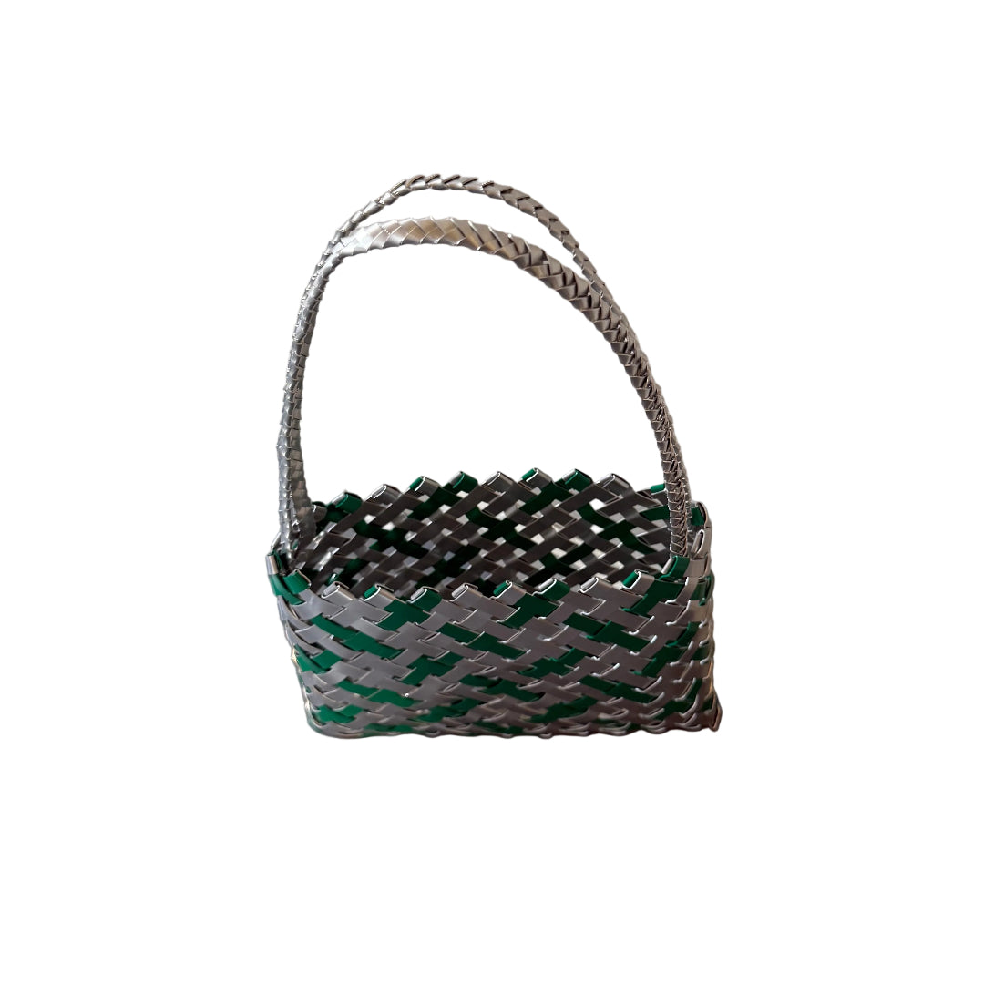Woven green and silver aluminium wall kete or bag on a white background