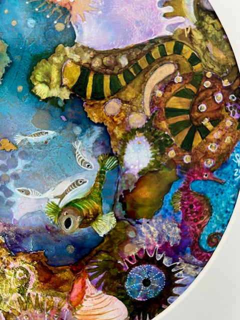 Colorful underwater scene with seahorses, fish, and coral.