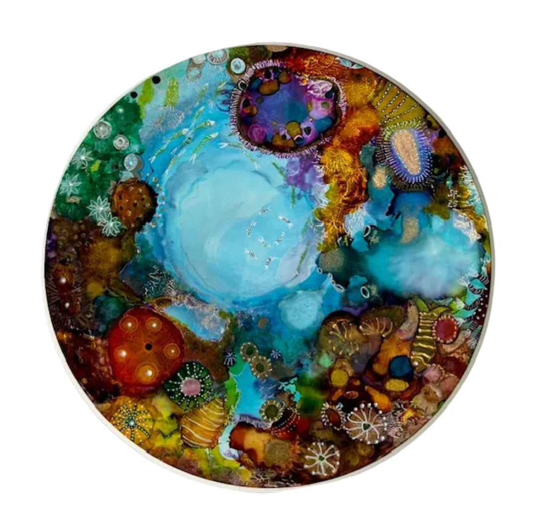 Circular artwork with colorful underwater scene on a white background