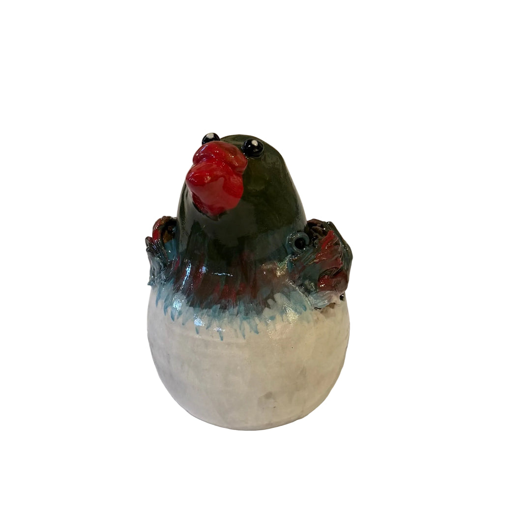 Ceramic Kereru bird sculpture with a red beak on a white background