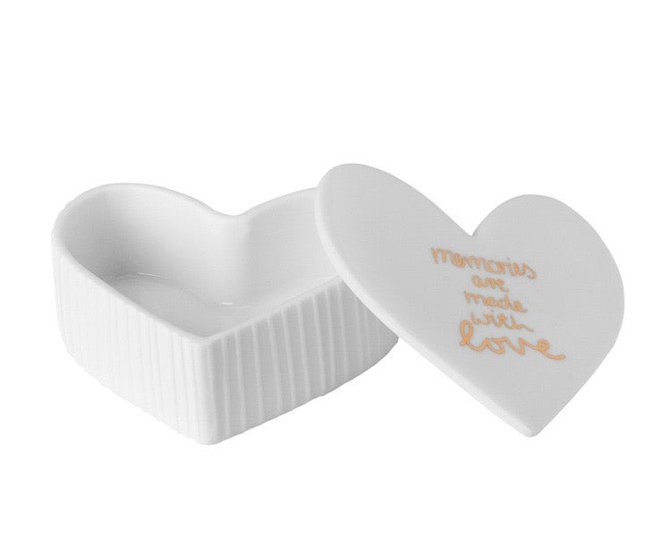 White fluted porcelain trinket box with 'Memories are made with love' written on the lid in gold.