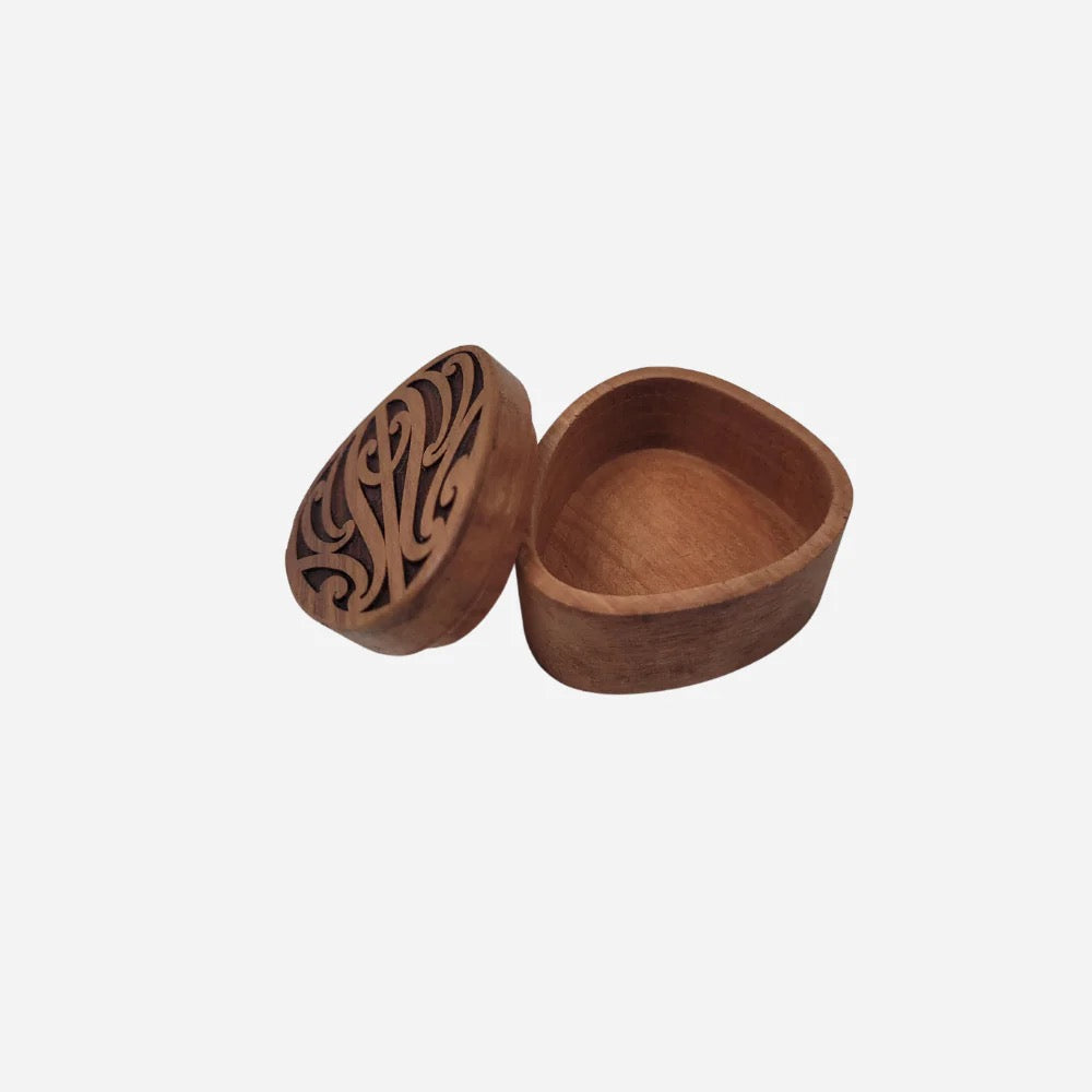 Wooden box with intricate carvings on a white background