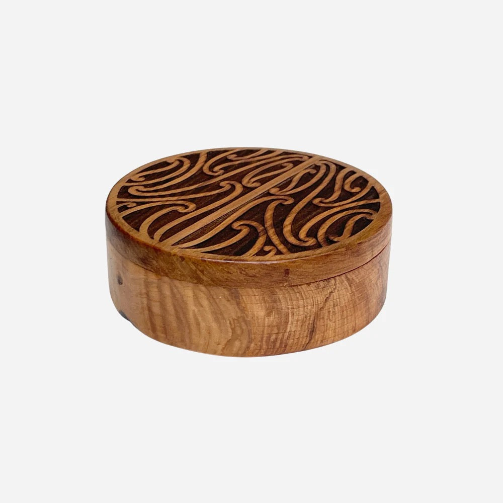 Wooden box with intricate carvings on a white background