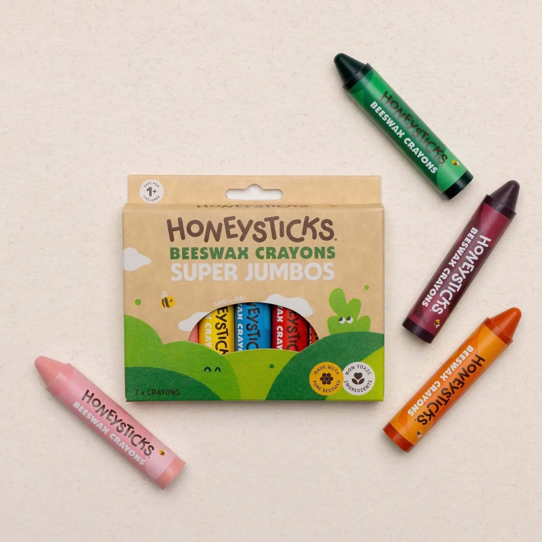 Honeysticks Beeswax Crayons packaging with multiple crayons on a beige background