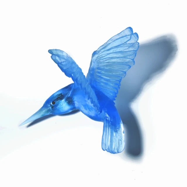 Blue glass kingfisher wall figurine on a white background