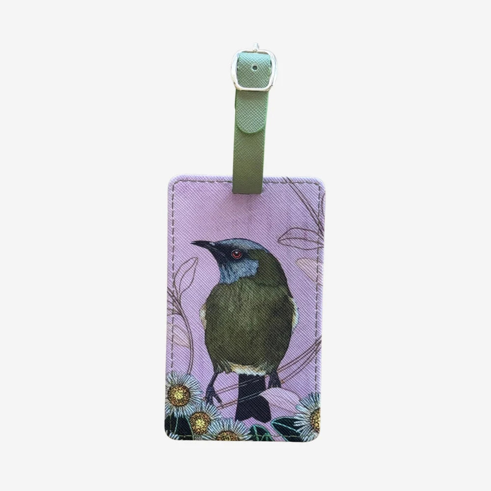 Luggage tag with a bird design on a light purple background