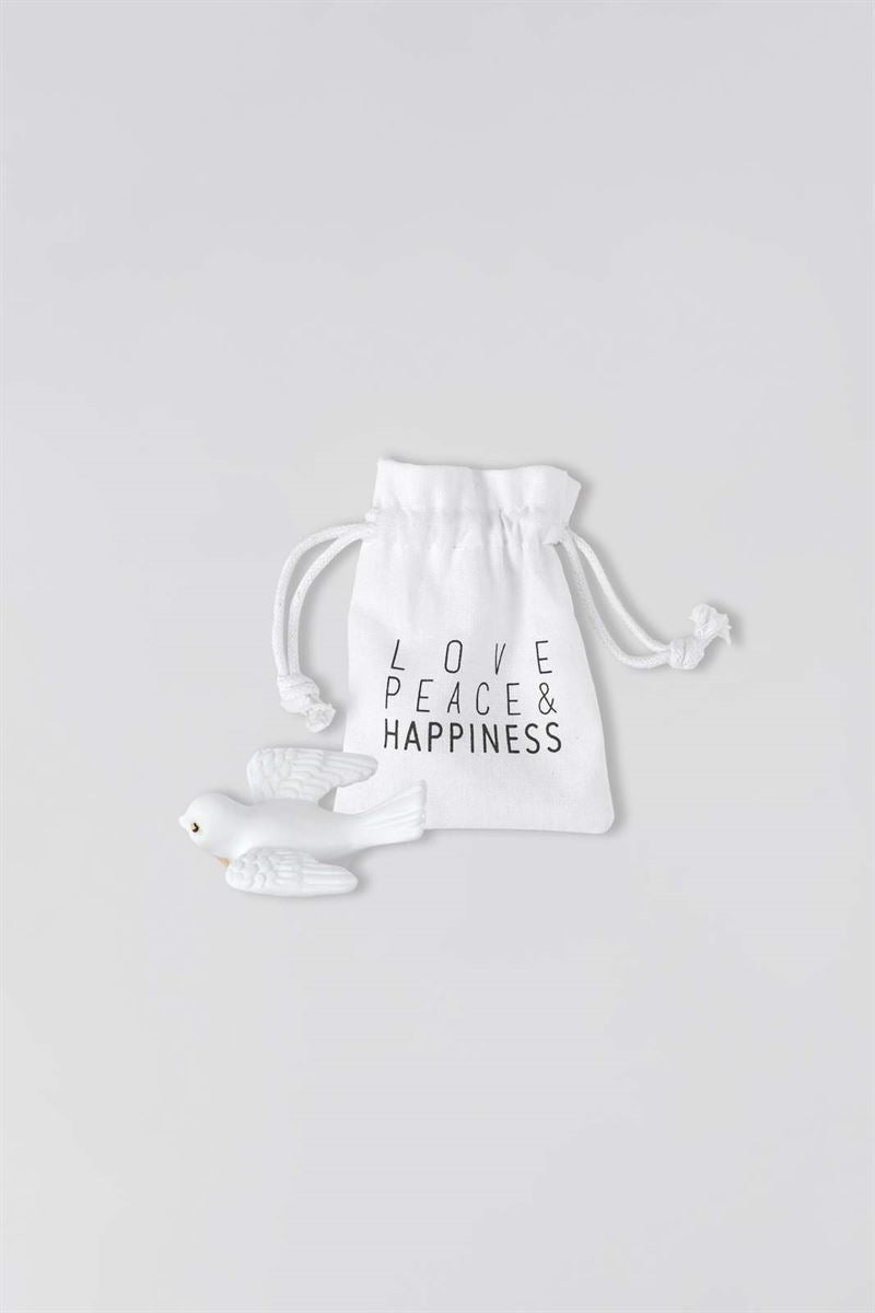 White dove with white drawstring bag with 'LOVE PEACE & HAPPINESS' text on a light gray background