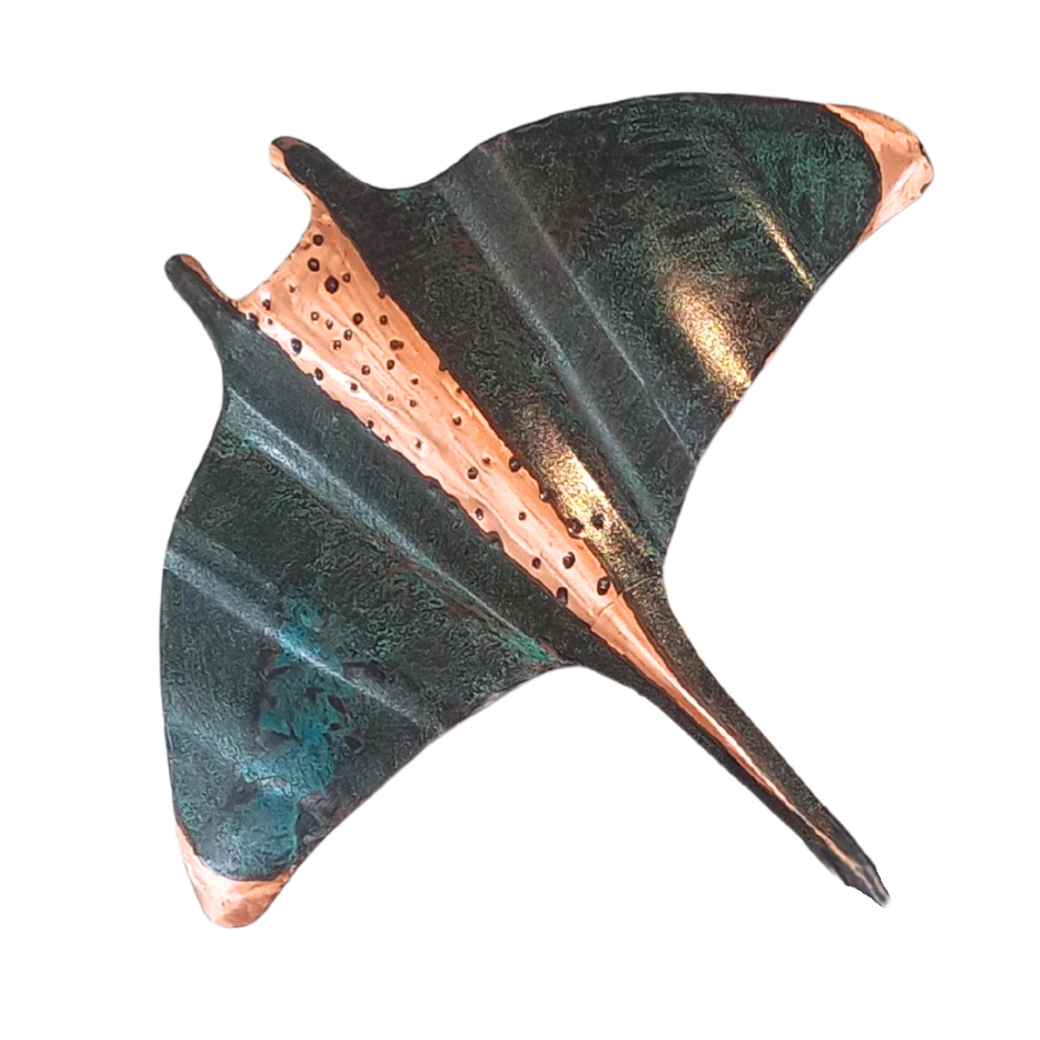 Decorative copper manta ray wall art on a white background